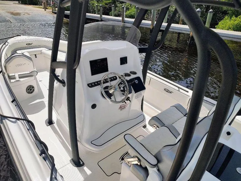 Slide: The Image of 2024 Glasstream 280 Pro-XS boat interior with steering console and seating. - 5