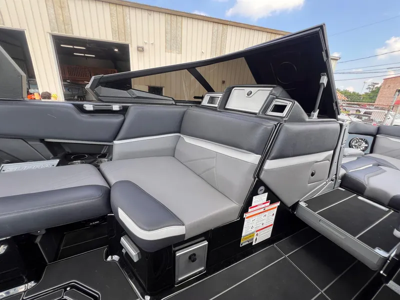 Slide: The Image of 2023 Supra SL 450 boat interior with sleek gray and black seating. - 12