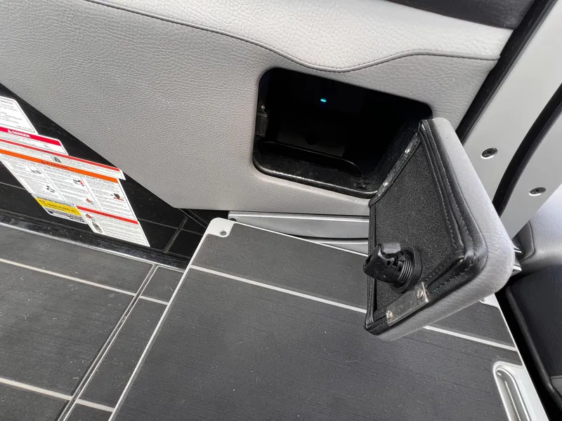 Slide: The Image of 2023 Supra SL 450 interior compartment with open storage panel. - 13