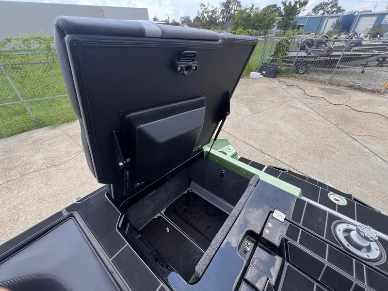 Slide: The Image of 2023 Supra SL 450 boat storage compartment open, showcasing interior space. - 14