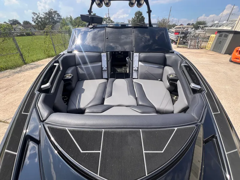 Slide: The Image of 2023 Supra SL 450 boat interior with sleek black and gray seating. - 15