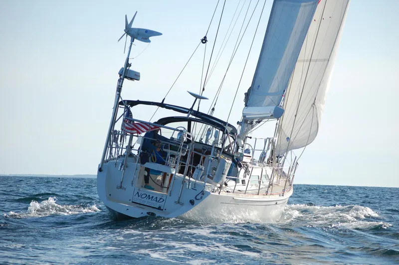 Slide: The Image of Sailing yacht Outbound 46, 2007 model, navigating ocean waters with full sails. - 1