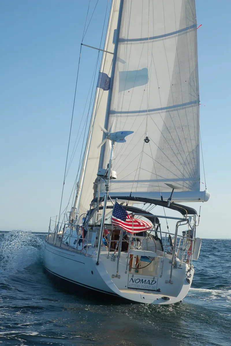 Slide: The Image of Sailing yacht "Nomad" on open sea, Outbound 46, 2007 model, with American flag. - 10