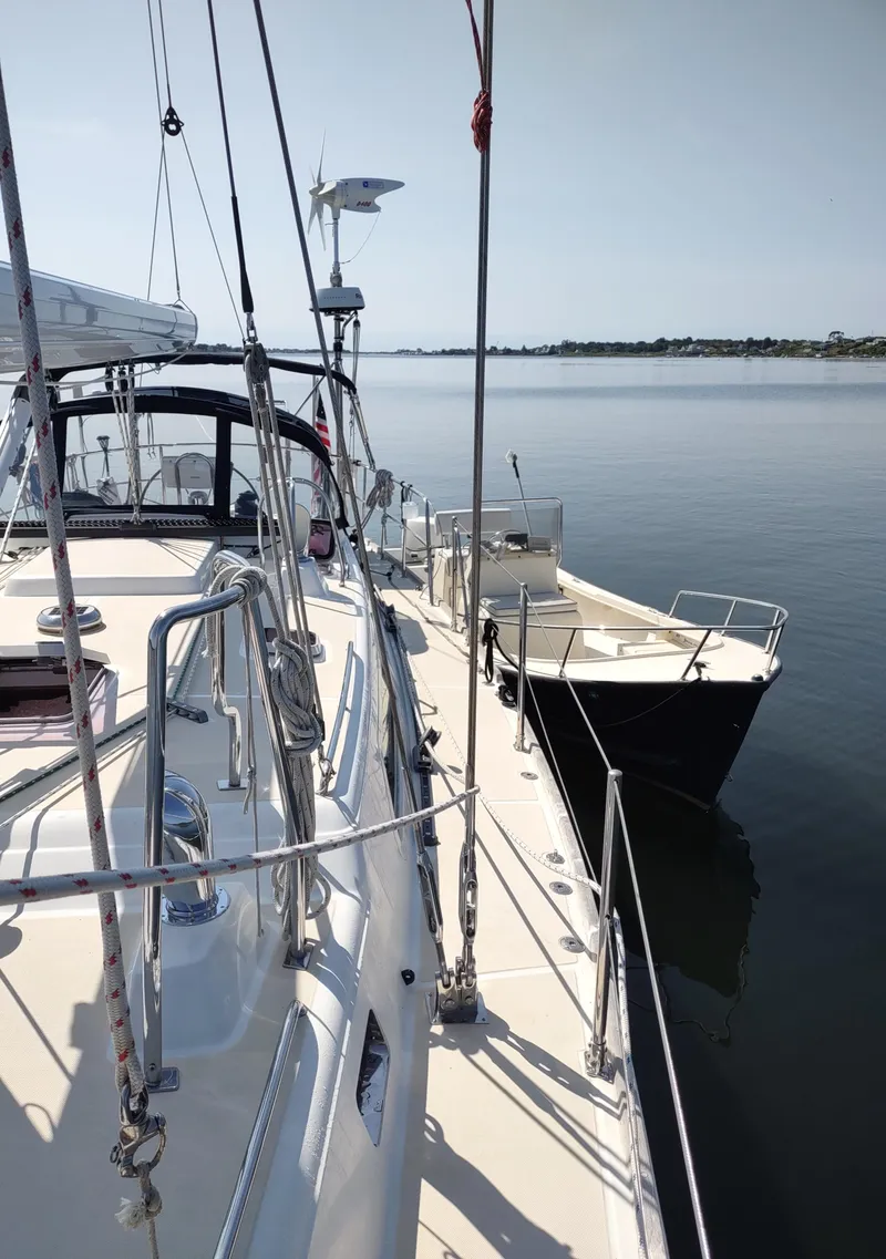 Slide: The Image of Sailboat Outbound 46, 2007 model, docked on calm water under clear sky. - 18