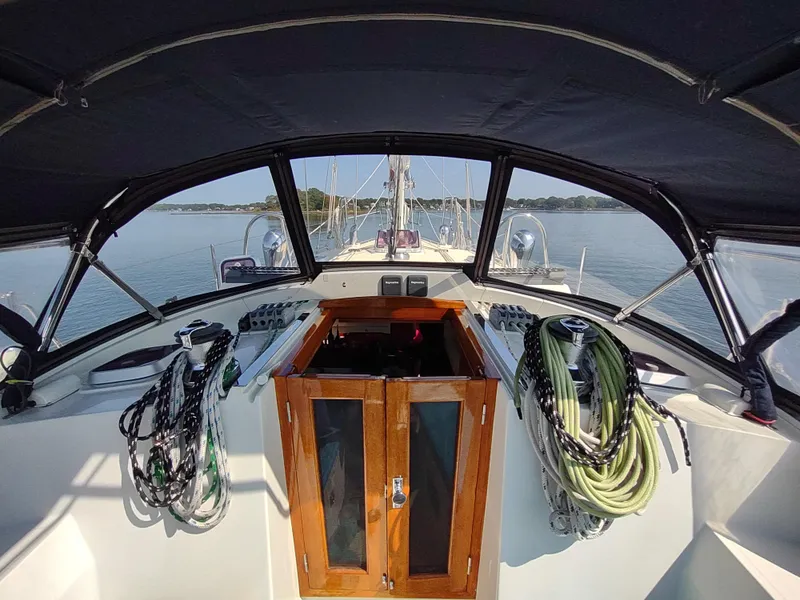 Slide: The Image of Cockpit view of 2007 Outbound 46 sailboat with ropes and wooden hatch. - 22