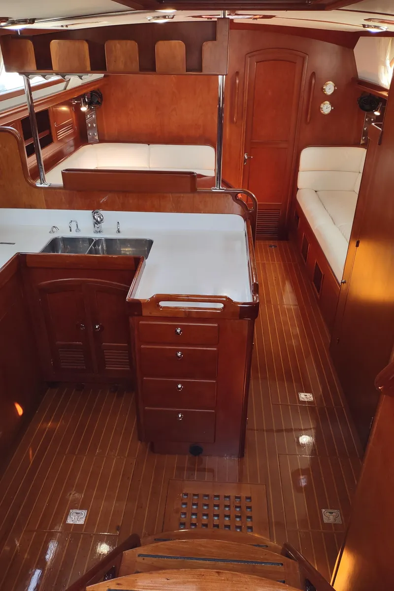 Slide: The Image of Luxurious 2007 Outbound 46 yacht interior with wood finishes and cozy seating. - 23