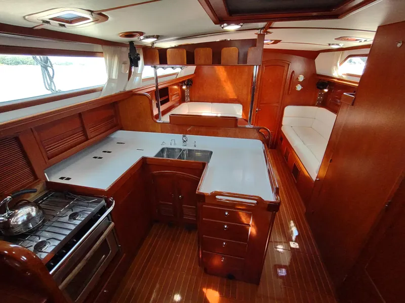 Slide: The Image of Luxurious 2007 Outbound 46 yacht interior with wood finish and modern kitchen amenities. - 24