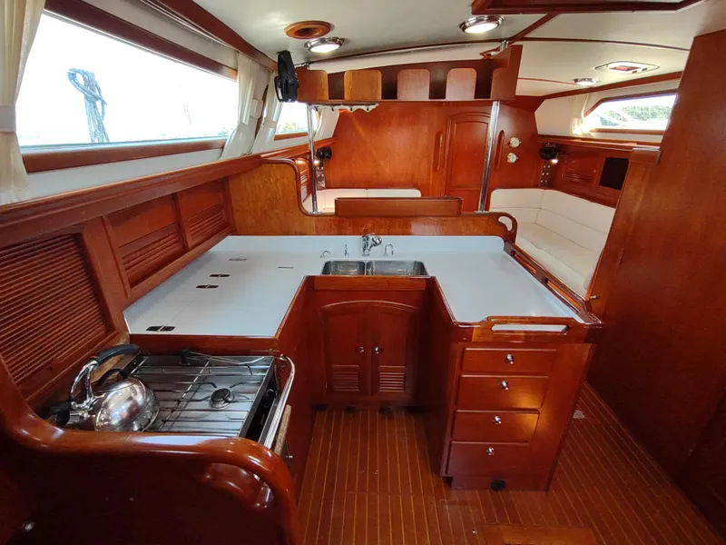 Slide: The Image of Luxurious 2007 Outbound 46 yacht interior with wooden cabinetry and modern kitchen amenities. - 29