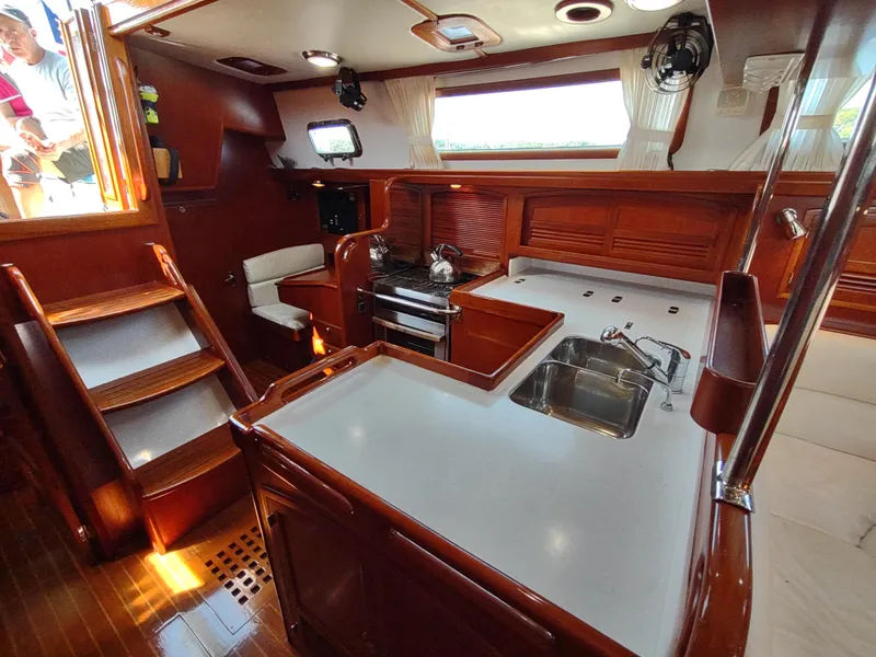 Slide: The Image of Luxurious 2007 Outbound 46 yacht interior with modern kitchen and wooden finishes. - 30