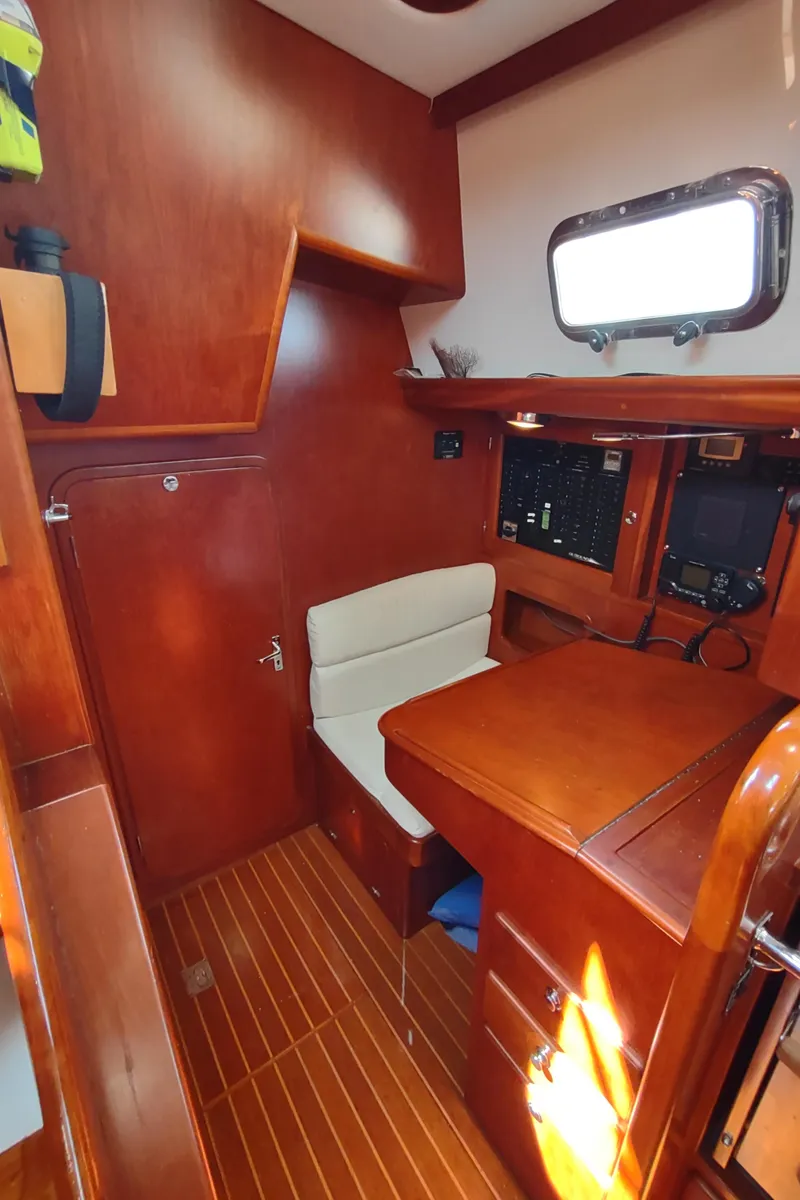 Slide: The Image of 2007 Outbound 46 yacht interior with wooden cabinetry and navigation station. - 31