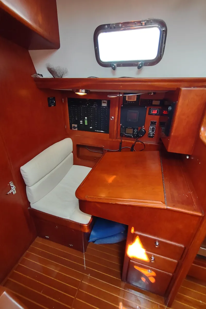 Slide: The Image of 2007 Outbound 46 yacht interior with navigation station and wooden cabinetry. - 32