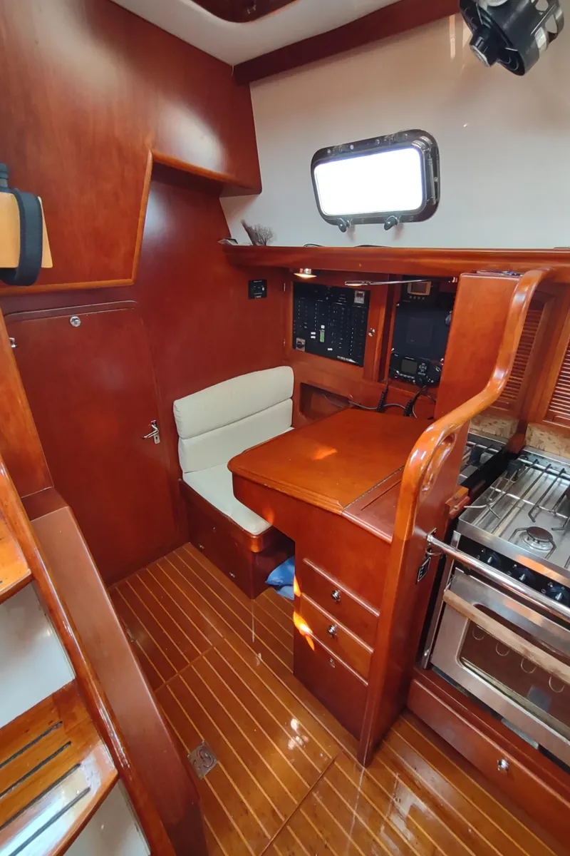 Slide: The Image of Interior of 2007 Outbound 46 yacht with wood finish and compact kitchen area. - 33