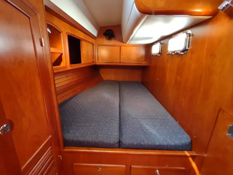 Slide: The Image of Cabin interior of 2007 Outbound 46 yacht with wooden finish and cozy bedding. - 35