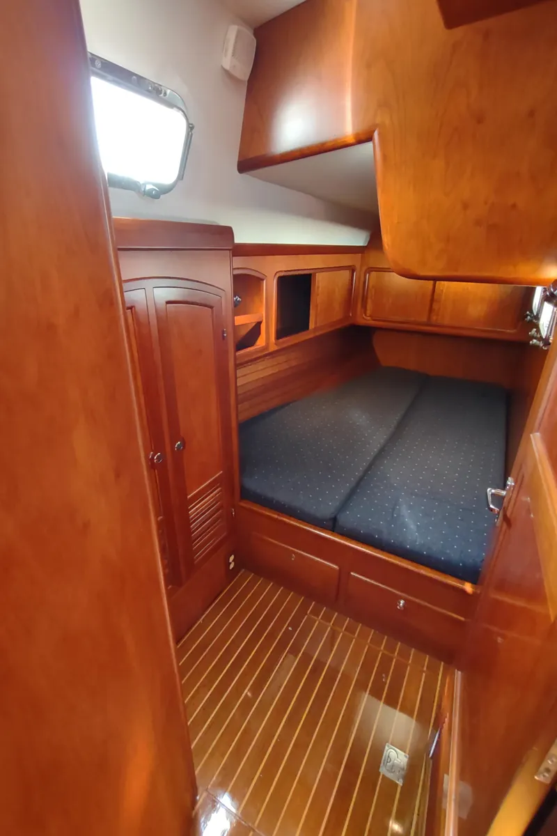 Slide: The Image of Cozy cabin interior of 2007 Outbound 46 yacht with wooden finish and comfortable bedding. - 36
