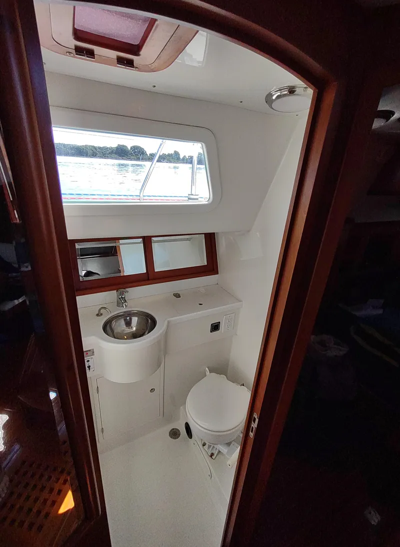Slide: The Image of Compact bathroom in 2007 Outbound 46 yacht with sink, toilet, and window. - 38