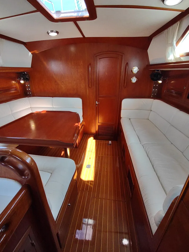 Slide: The Image of Luxurious 2007 Outbound 46 yacht interior with elegant wood finish and plush seating. - 41