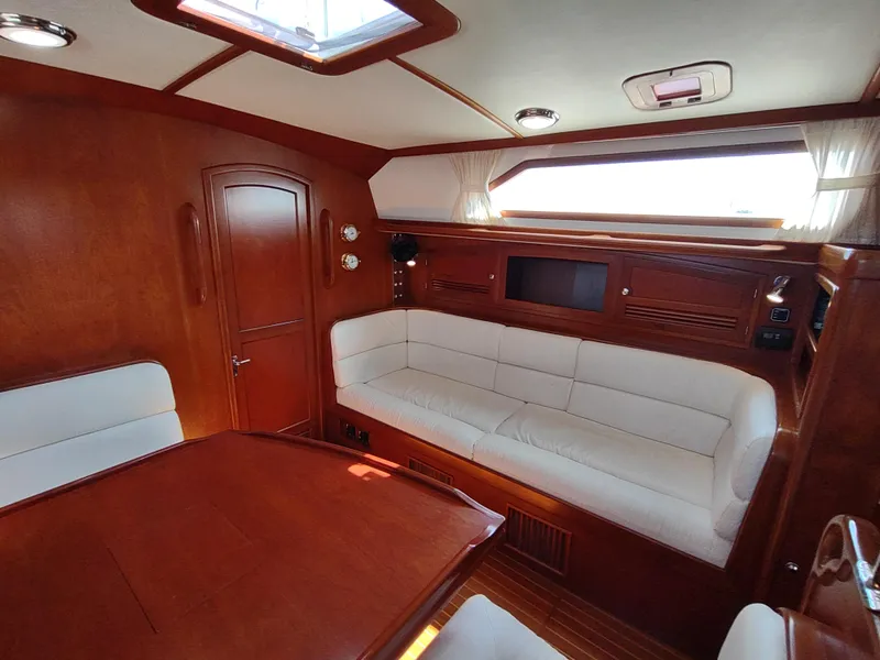 Slide: The Image of Luxurious interior of 2007 Outbound 46 yacht with wooden finish and white seating. - 42