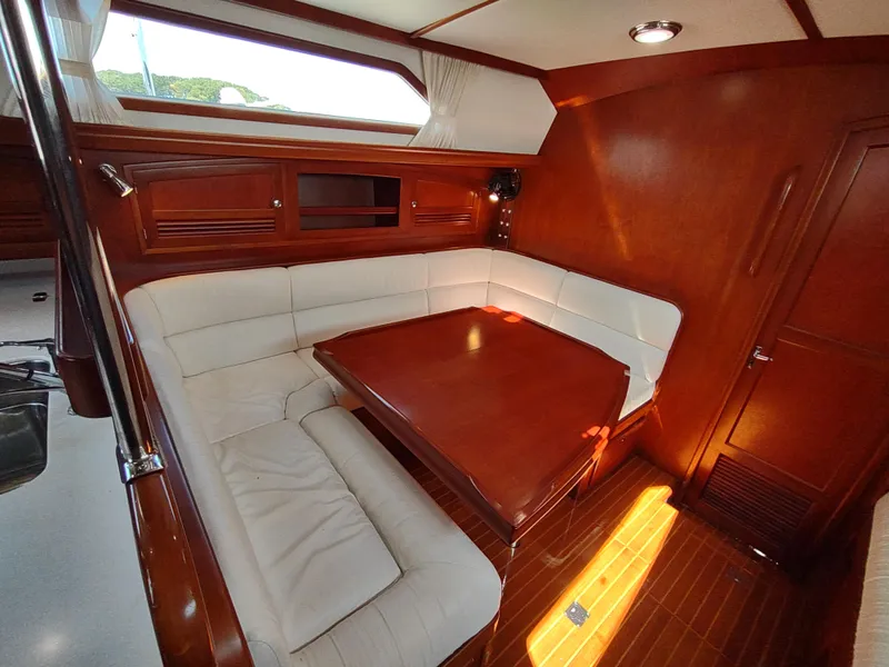 Slide: The Image of Luxurious interior of 2007 Outbound 46 yacht with elegant wood finish and cozy seating area. - 43