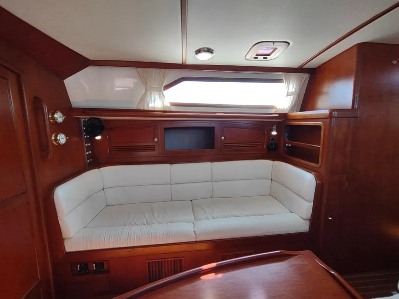 Slide: The Image of Luxurious interior of 2007 Outbound 46 yacht with plush white seating and wooden accents. - 45