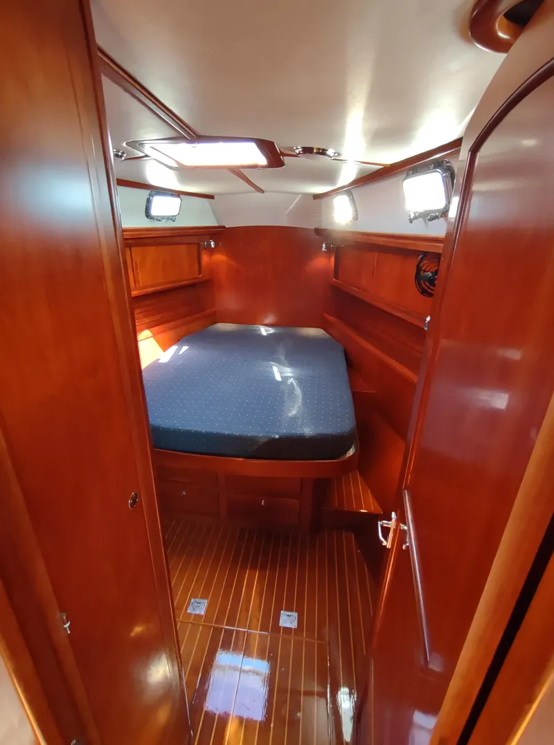 Slide: The Image of Luxurious cabin interior of 2007 Outbound 46 yacht with wooden finish and cozy bed. - 48