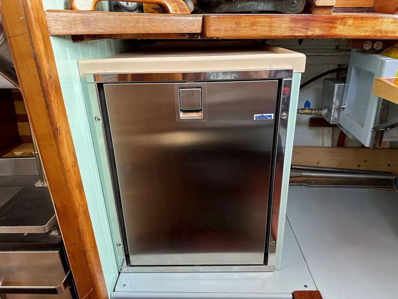Slide: The Image of Stainless steel refrigerator in a 1947 William Garden 36 Custom Yawl interior. - 4