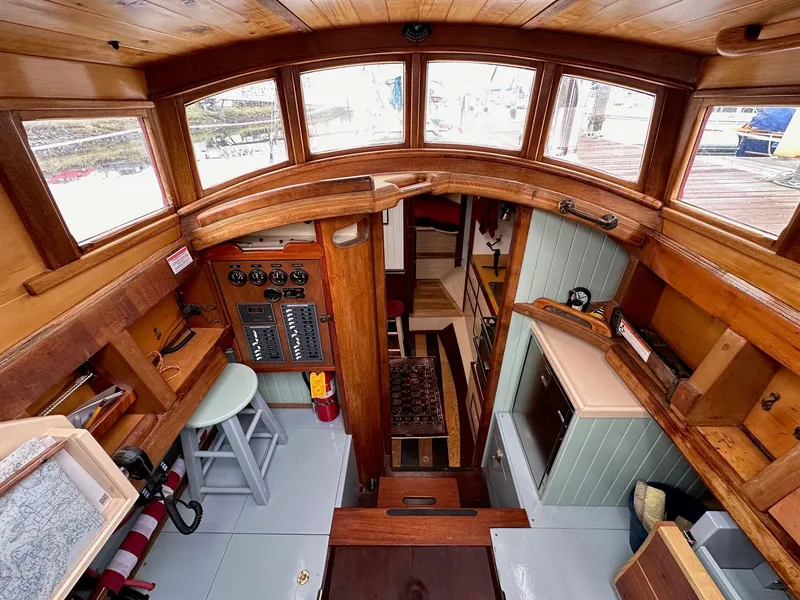 Slide: The Image of Interior of 1947 William Garden 36 Custom Yawl, featuring wooden finishes and nautical equipment. - 8