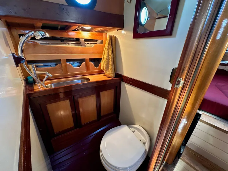 Slide: The Image of Vintage 1947 William Garden 36 Custom Yawl bathroom with wooden cabinetry and nautical decor. - 9