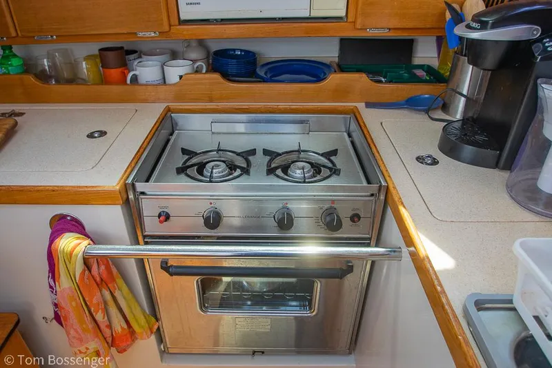 Slide: The Image of Compact kitchen in a 2002 Catalina 36 MkII sailboat with a stainless steel stove and oven. - 11