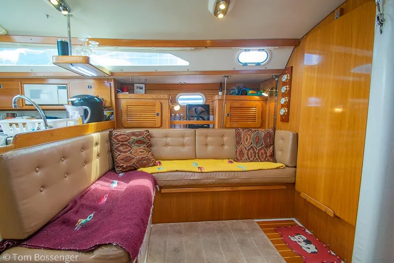 Slide: The Image of Interior of a 2002 Catalina 36 MkII sailboat with cozy seating and wooden accents. - 17
