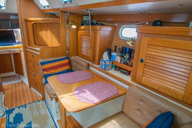 Slide: The Image of Interior of 2002 Catalina 36 MkII sailboat with cozy dining area and wooden cabinetry. - 21