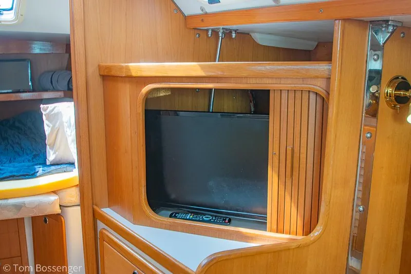 Slide: The Image of Interior of 2002 Catalina 36 MkII sailboat with wooden cabinetry and built-in TV. - 23