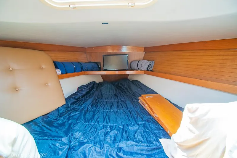 Slide: The Image of Cozy cabin interior of 2002 Catalina 36 MkII sailboat with blue bedding and wooden accents. - 24