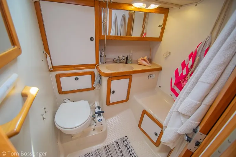 Slide: The Image of Bathroom interior of a 2002 Catalina 36 MkII sailboat, featuring wood accents and modern fixtures. - 25