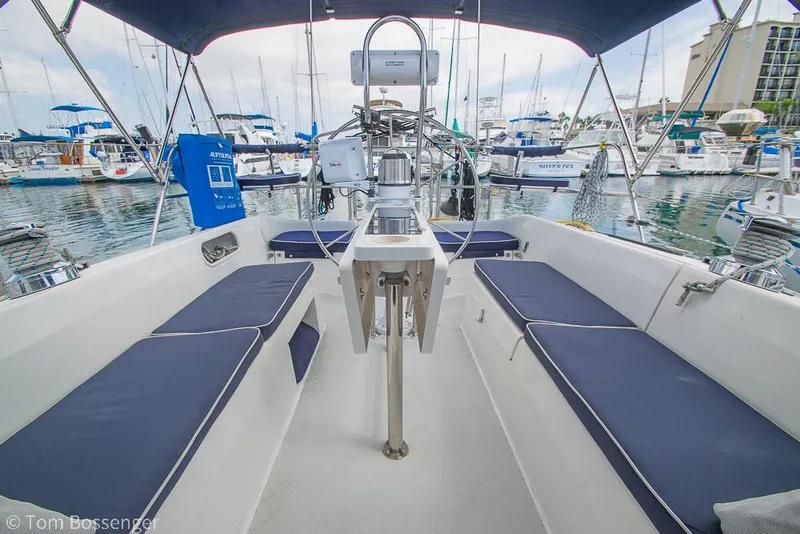 Slide: The Image of 2002 Catalina 36 MkII sailboat cockpit with blue cushions, docked in a marina. - 42