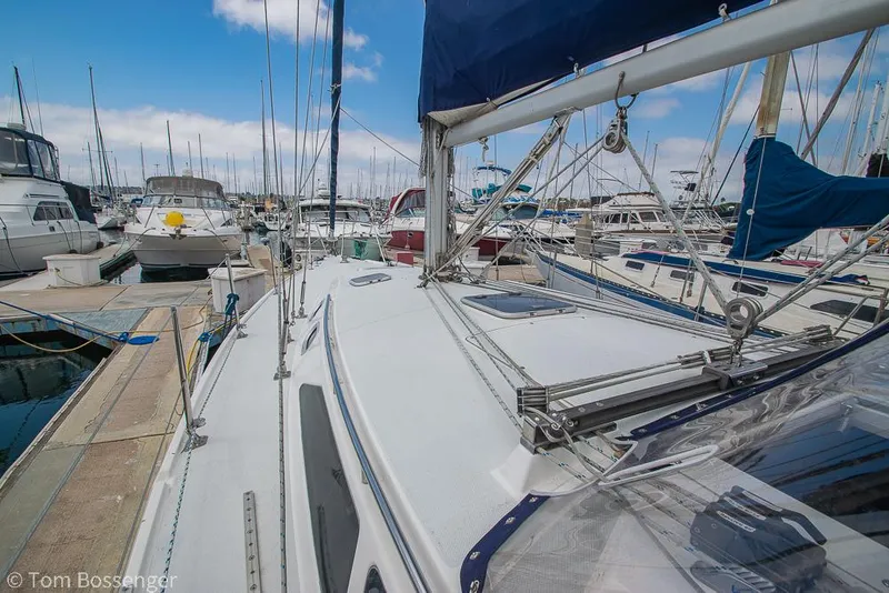 Slide: The Image of 2002 Catalina 36 MkII sailboat docked in a marina, surrounded by other boats. - 43