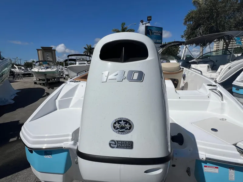 Slide: The Image of 2024 NauticStar 193SC Sport Deck boat with 140 horsepower engine, displayed outdoors. - 10