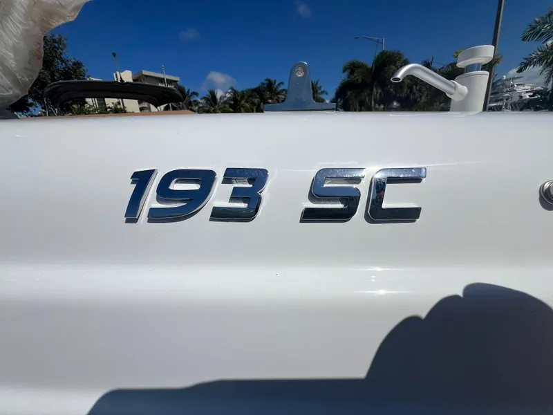 Slide: The Image of 2024 NauticStar 193SC Sport Deck boat emblem in sunlight. - 12