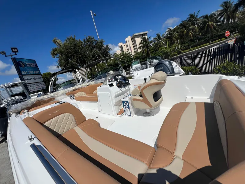 Slide: The Image of 2024 NauticStar 193SC Sport Deck boat with tan seating, outdoor display. - 5