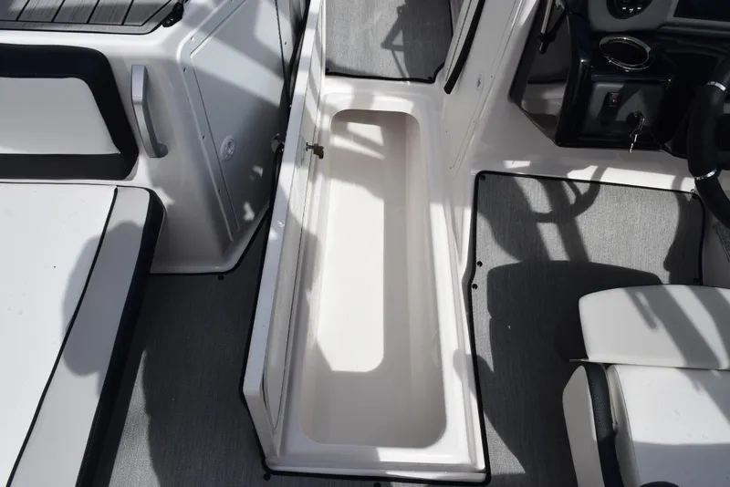 Slide: The Image of 2025 Yamaha Boats AR195 interior storage compartment with sleek design and modern features. - 15