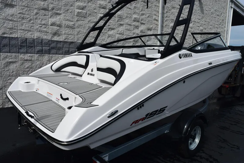 Slide: The Image of 2025 Yamaha Boats AR195, sleek white design, on trailer, ready for adventure. - 3
