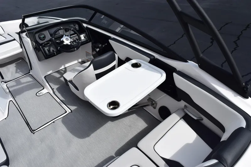 Slide: The Image of 2025 Yamaha Boats AR195 interior with steering wheel, seating, and table setup. - 9