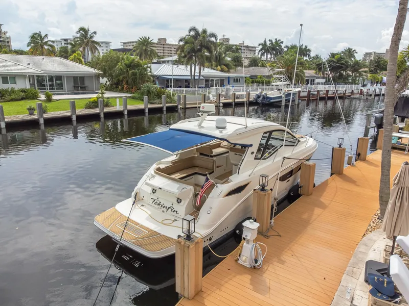 Slide: The Image of 2019 Sea Ray Sundancer 350 Coupe docked by waterfront homes. - 11