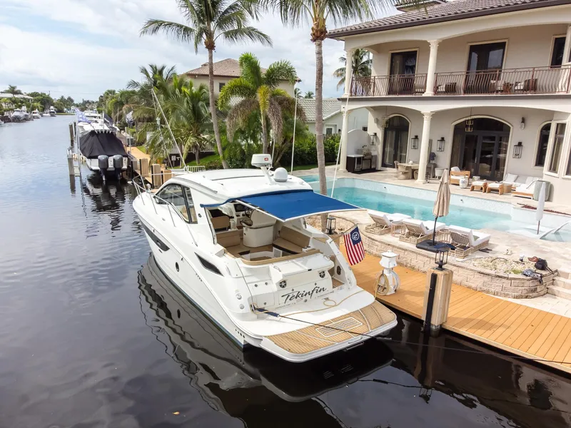 Slide: The Image of 2019 Sea Ray Sundancer 350 Coupe docked by luxury waterfront home. - 13