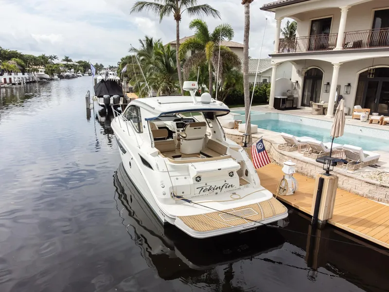 Slide: The Image of 2019 Sea Ray Sundancer 350 Coupe docked by luxurious waterfront home. - 15