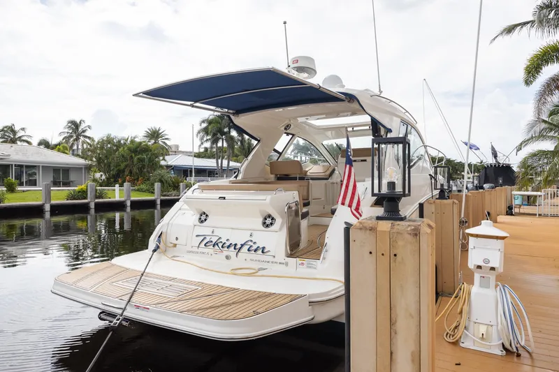 Slide: The Image of 2019 Sea Ray Sundancer 350 Coupe docked by a waterfront home. - 20