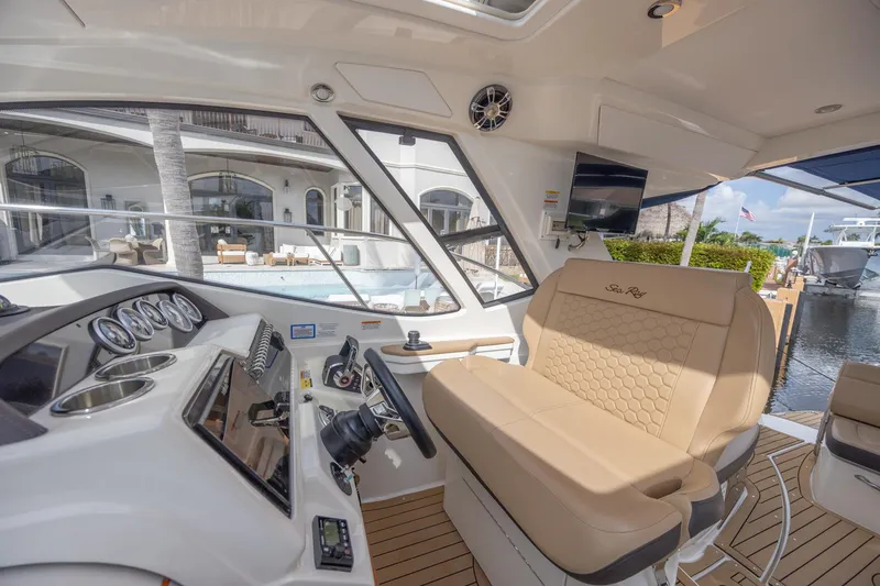 Slide: The Image of Interior of 2019 Sea Ray Sundancer 350 Coupe with helm and seating area. - 32
