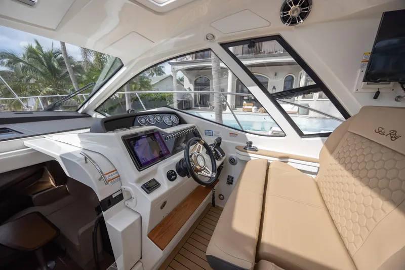 Slide: The Image of 2019 Sea Ray Sundancer 350 Coupe cockpit with modern controls and luxurious seating. - 33