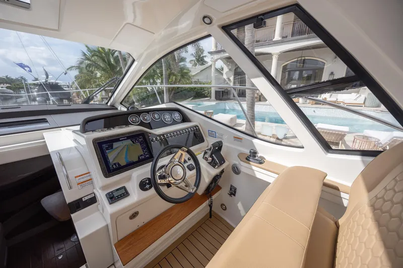 Slide: The Image of Interior of 2019 Sea Ray Sundancer 350 Coupe, featuring modern helm and luxurious seating. - 37
