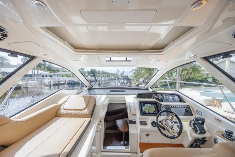 Slide: The Image of Luxurious interior of 2019 Sea Ray Sundancer 350 Coupe yacht with modern helm and seating. - 39