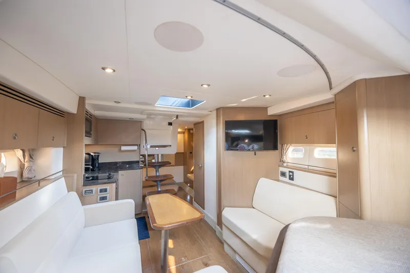 Slide: The Image of Interior of 2019 Sea Ray Sundancer 350 Coupe, featuring modern seating and entertainment area. - 42